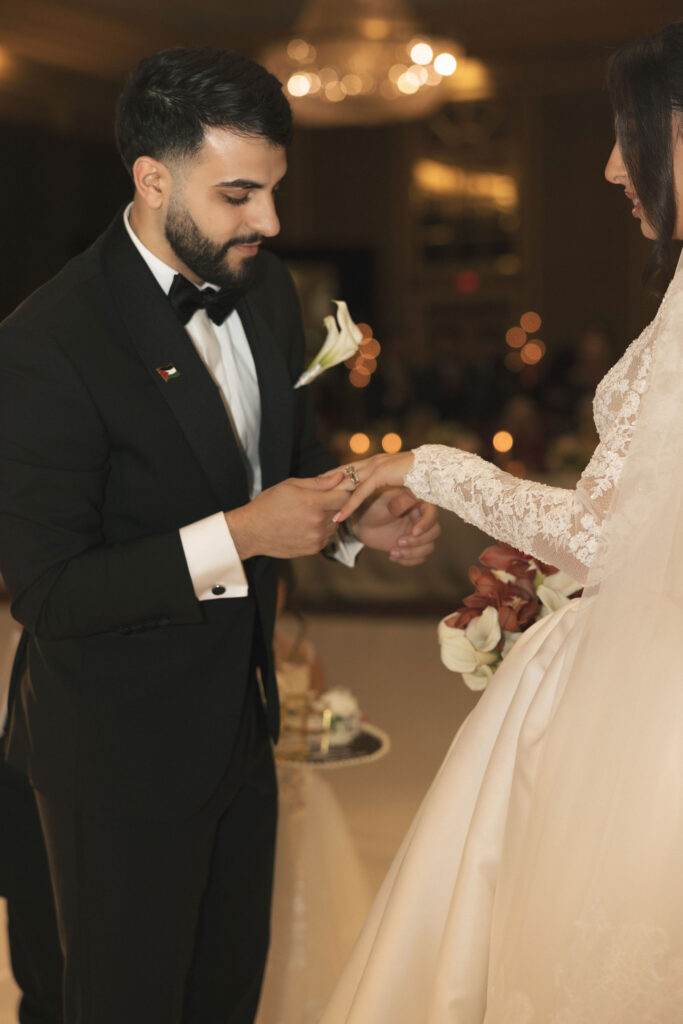 groom giving bride ring