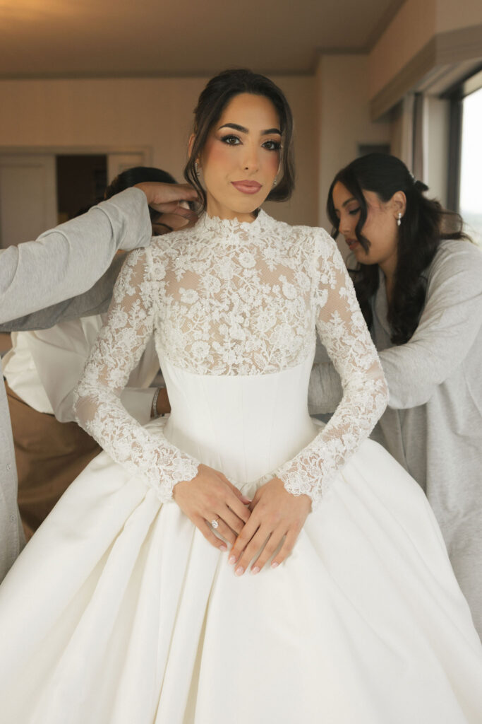 finishing touches on bride getting ready