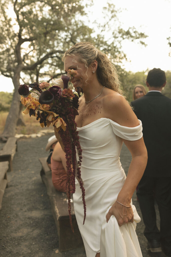 bride smiling with wedding bouquet