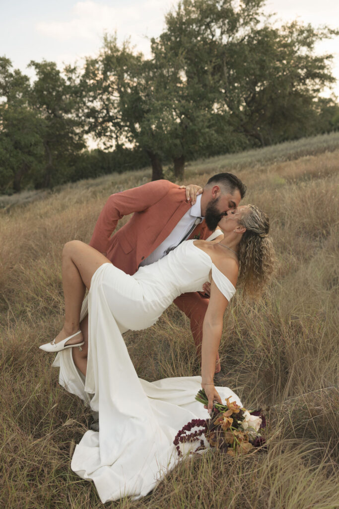 groom dipping bride on wedding day