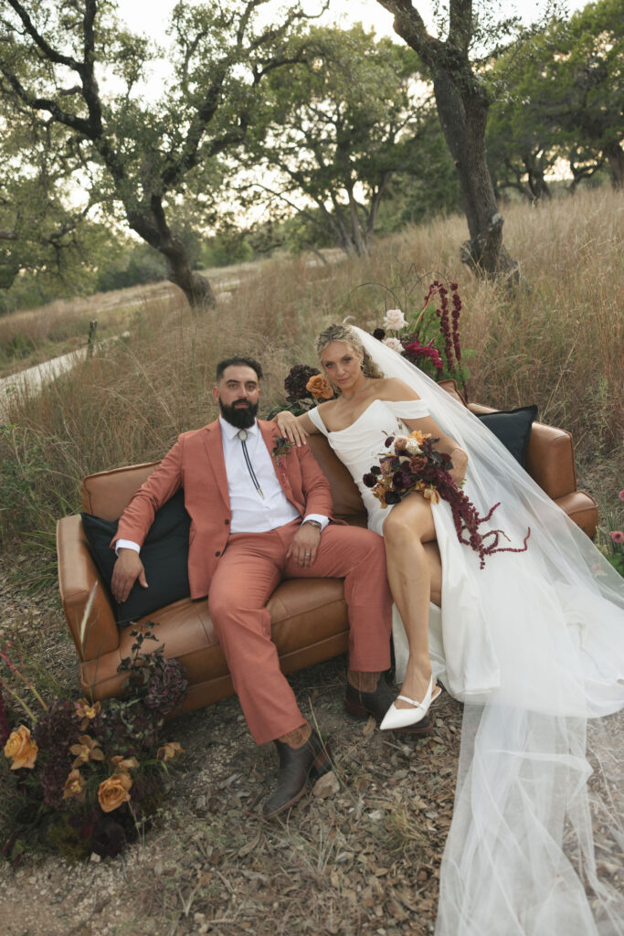bride and groom on couch on wedding day