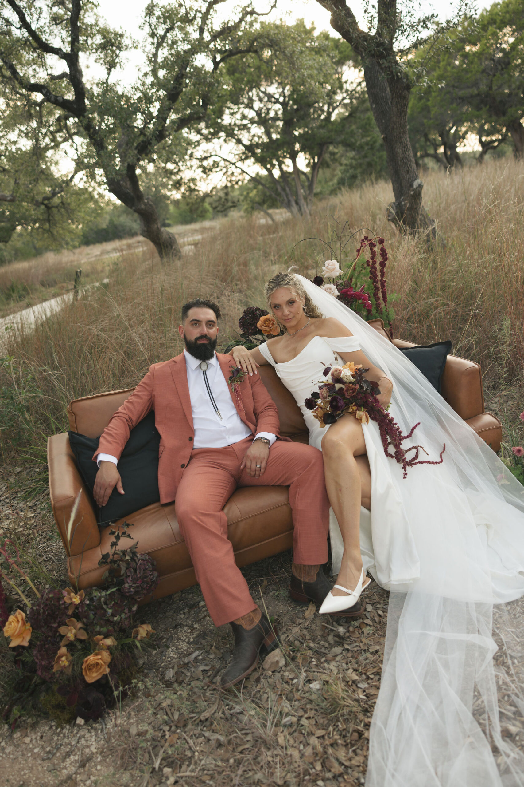 bride and groom on couch on wedding day