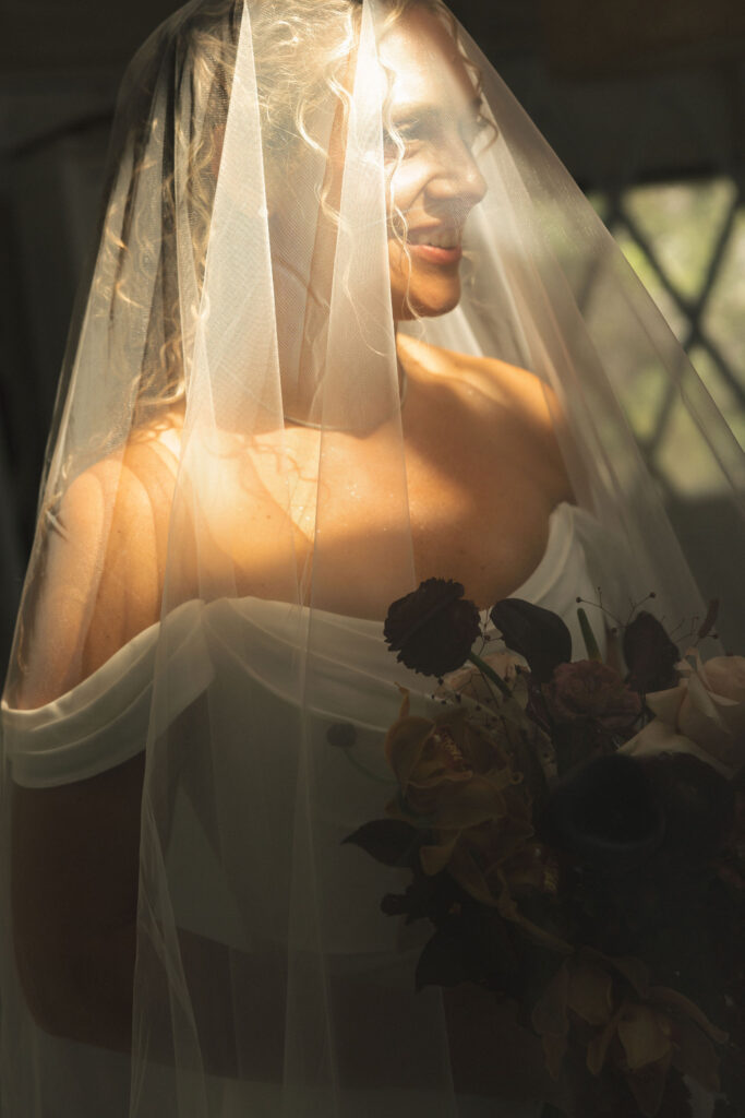 bride in veil in dramatic lighting