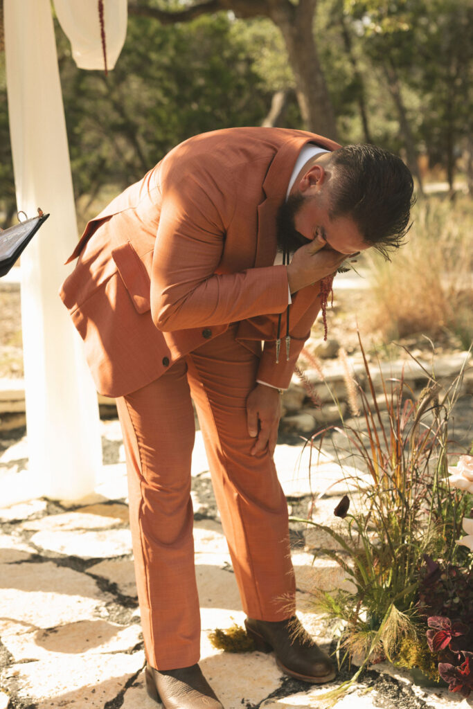 groom crying seeing the bride