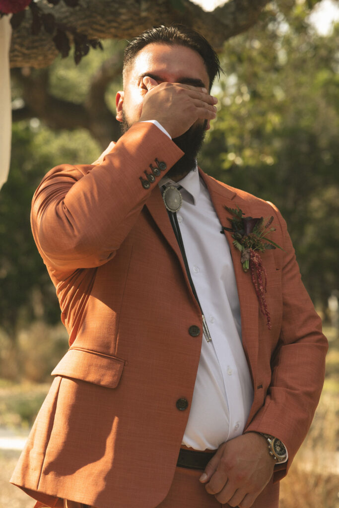 groom crying at wedding ceremony