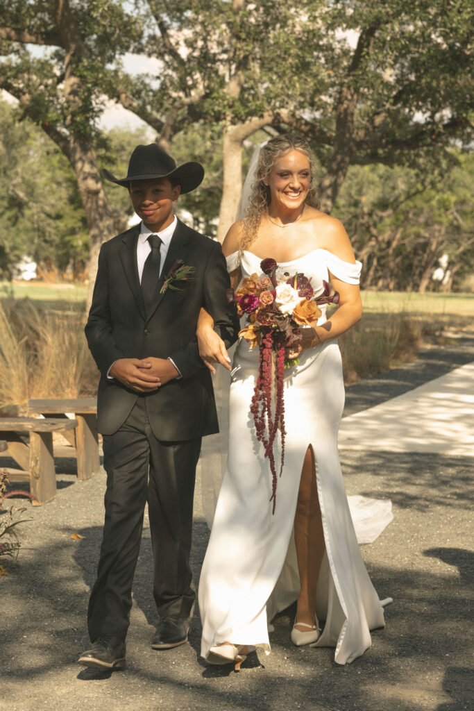 bride walking down the aisle in Wimberly Texas at the cedars ranch