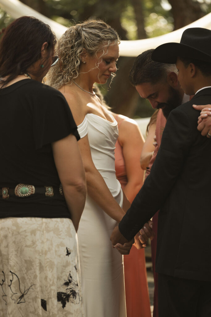 family praying together at wedding
