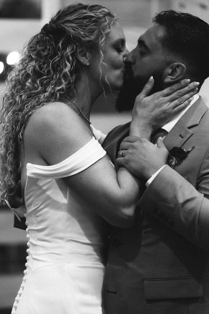 bride and groom kiss during first dance