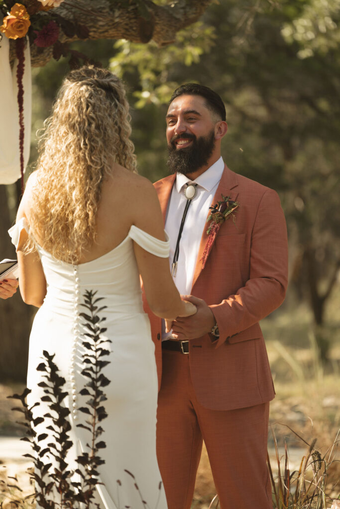 groom smiling during wedding ceremony